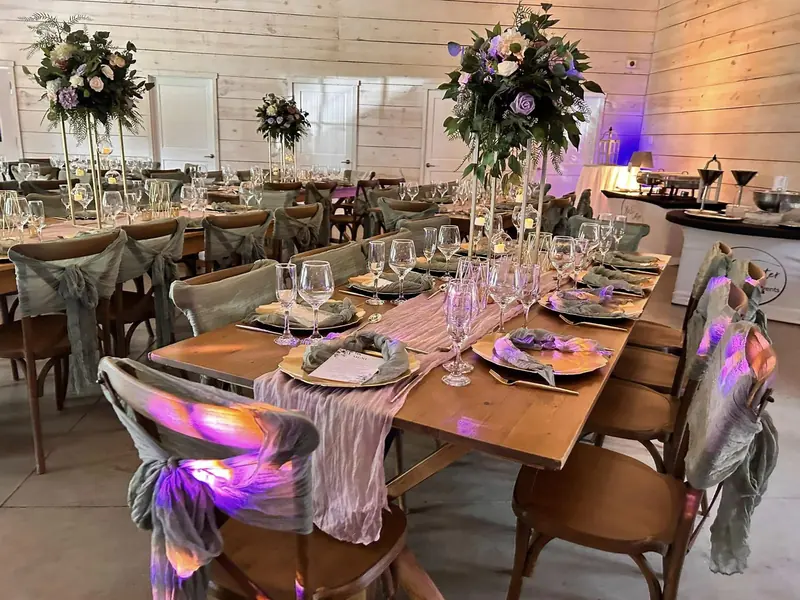 Barn reception with farm tables and florals