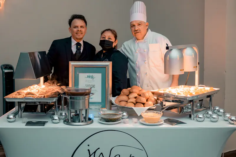 JW Cater chef and team behind a carving station with heat lamps and rolls