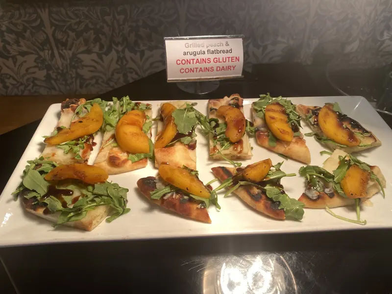 Platter of crostini with roasted peppers and greens