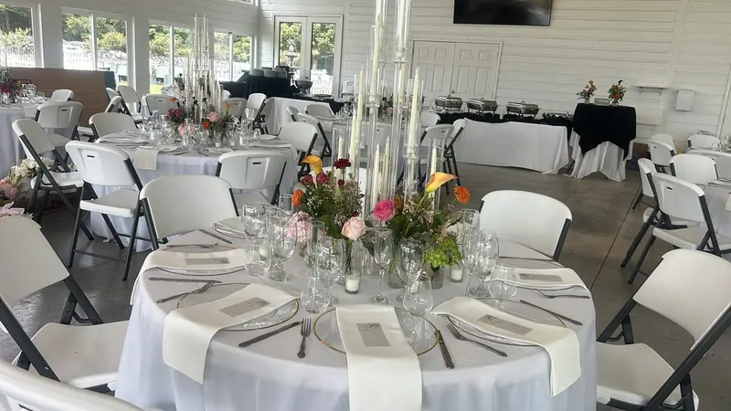 Wedding tables with clear chargers and colorful centerpieces