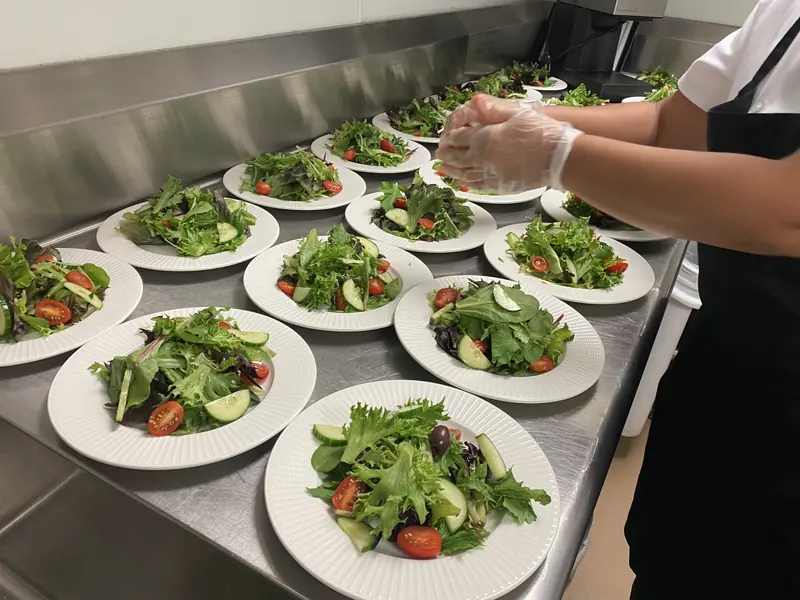 Rows of plated salads ready to be served