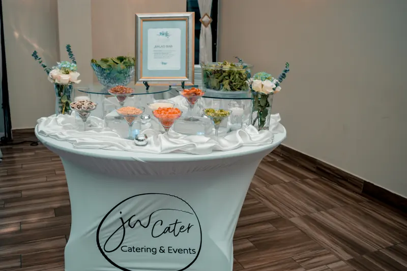 Round salad station on a white JW Cater table cover