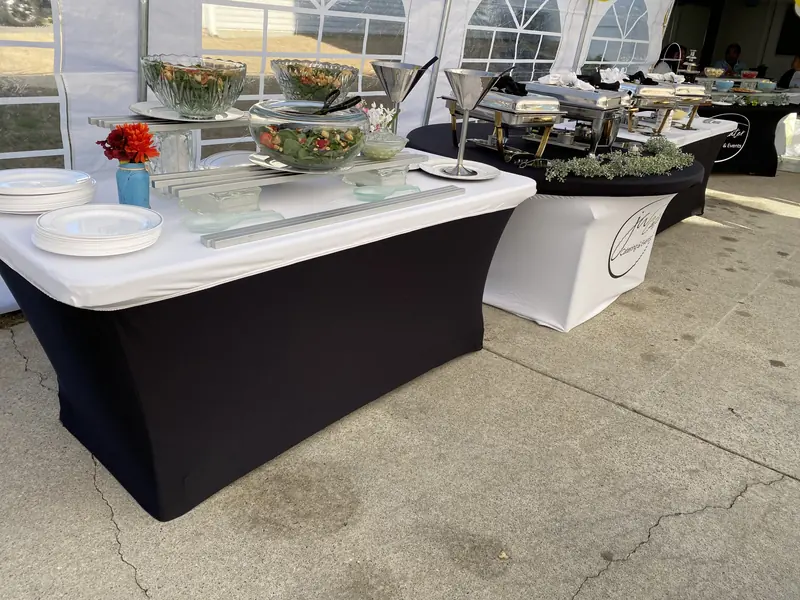 Salad and buffet stations set inside a party tent